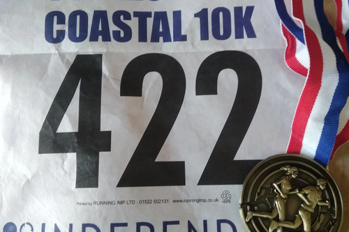 Folkestone Coastal 10km run - runners number and medal