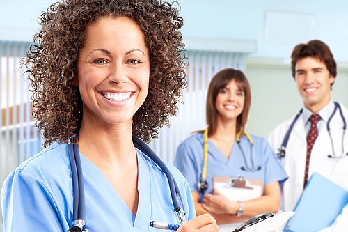 Three doctors smiling.