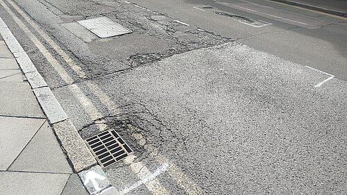 Potholes in road marked up for repair