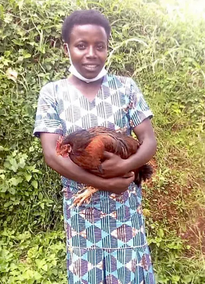 Image courtesy of Marianne (Haslegrave) gorillas@commat.org Sabina in new dress holding chicken