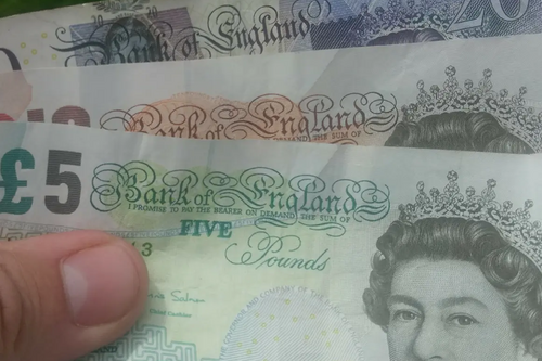 Money / banknotes (pounds sterling) in hand