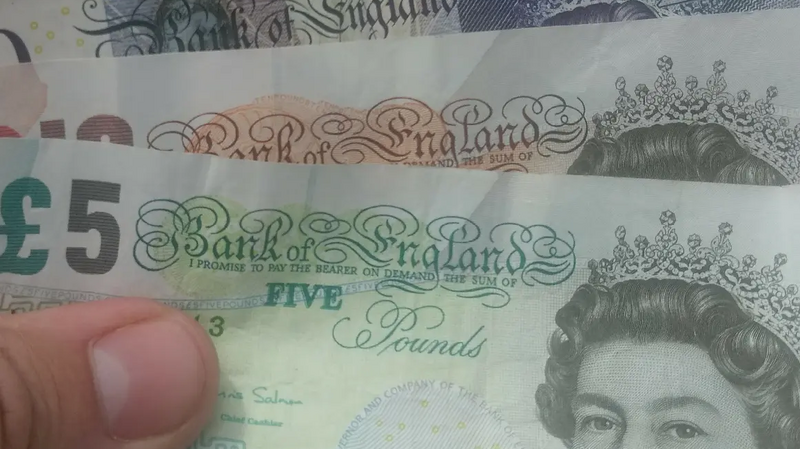 Money / banknotes (pounds sterling) in hand