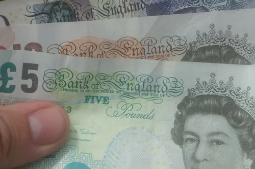 Money / banknotes (pounds sterling) in hand