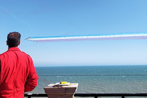 Red Arrows in flight with "Red One" commentary in foreground